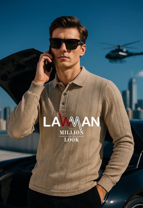 A man in sunglasses and a branded sweater standing next to a car with a helicopter in the background.